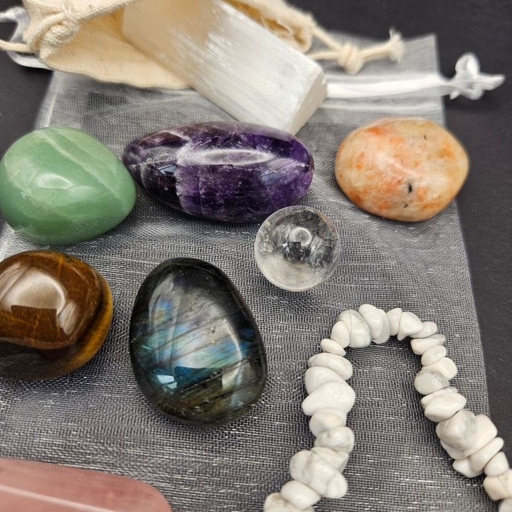 Everyday Bracelet &amp; Crystal Set gift package with a Howlite chip bracelet, polished Rose Quartz, Tiger Eye, Amethyst, and raw Selenite stick with organic storage bags. 