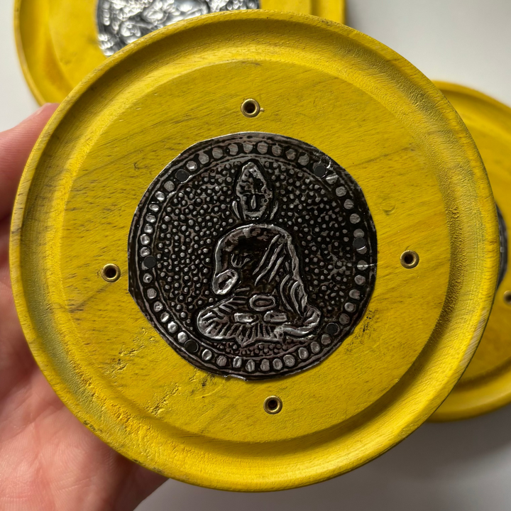 Buddha Incense Stick Holder held by a hand on a white background