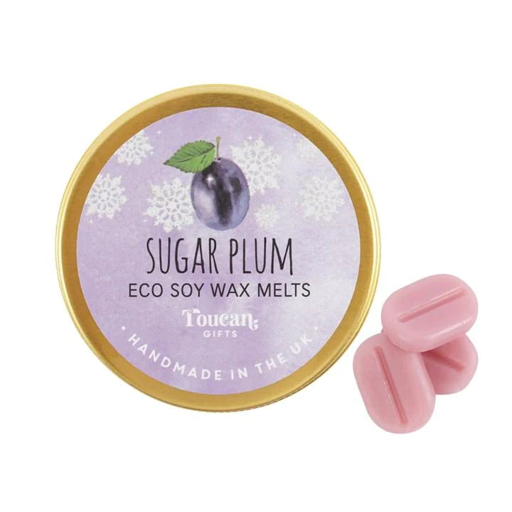 An open aluminium tin with the label 'Sugar Plum - Eco Soy Wax Melts' by Toucan, showing pink wax melts and the brand's logo.