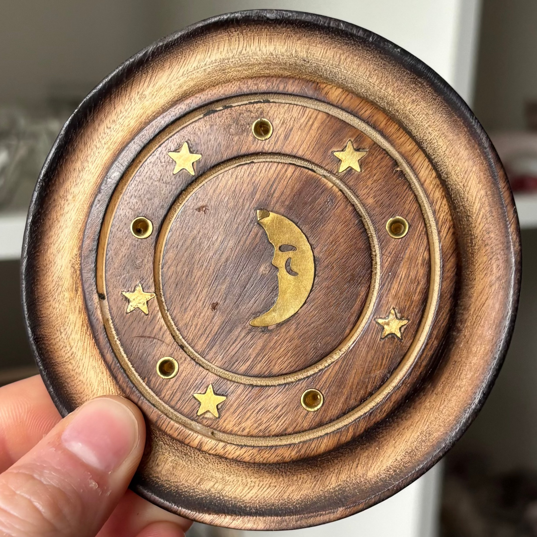 Half Moon Incense Stick Holder held by a hand against a blurred indoor background