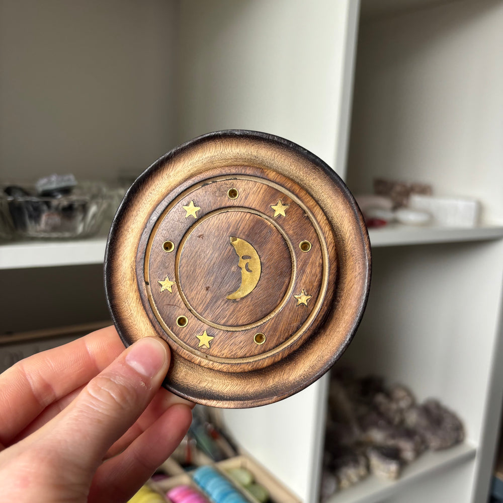 Half Moon Incense Stick Holder held by a hand against a blurred indoor background