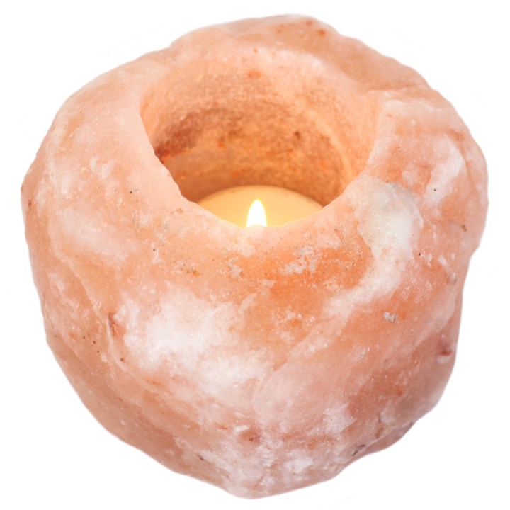 A Himalayan Salt Tea Light Holder with a burning candle on a plain white background