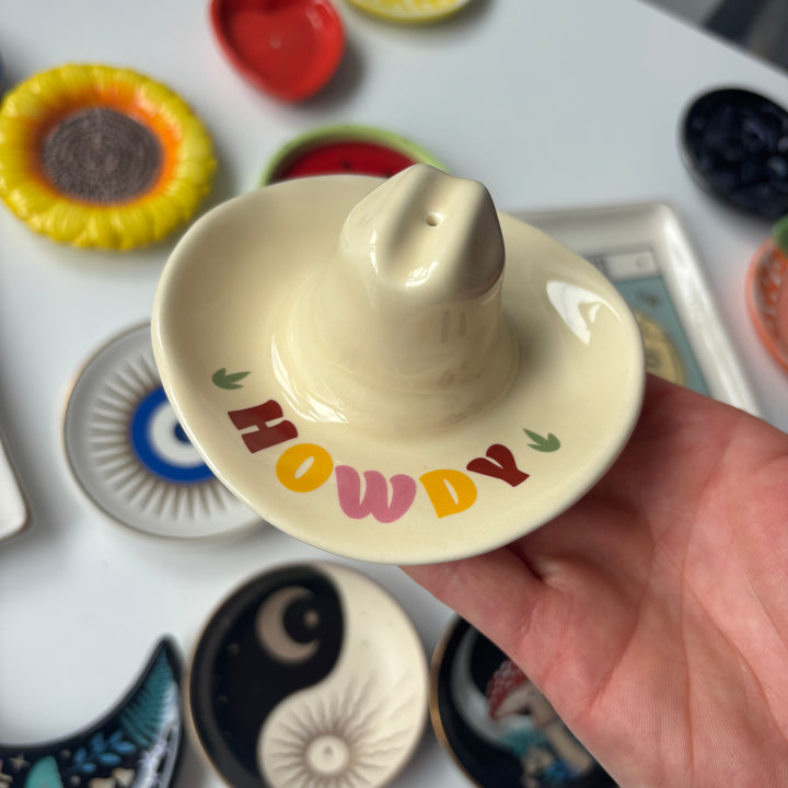 Hand holding a ceramic ring holder with &