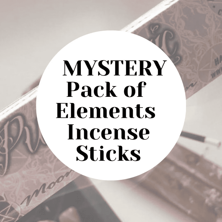 A retail graphic displaying a bold white circular label in the centre with clean black text reading Mystery Pack of Elements Incense Sticks. The minimalist overlay rests against a multi-coloured, out-of-focus background of whimsical Lisa Parker illustrated boxes to hint at an unexpected manifestation routine.