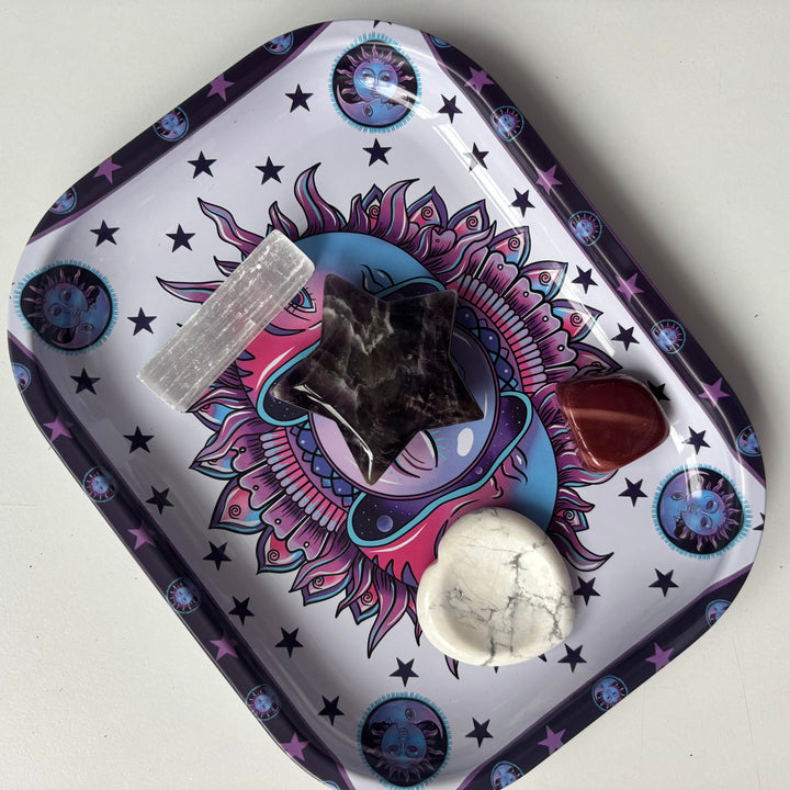 A top-down view of the celestial third eye tray holding a raw crystal cluster and a tumbled stone on a clean surface.