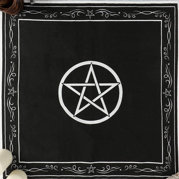 A top-down square studio shot of the black and white pentagon ritual cloth, showcasing its symmetrical geometric lines and ornate cotton border design against a clean white background.