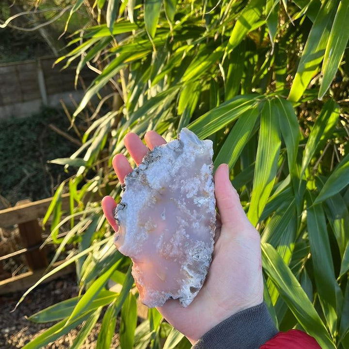 A polished agate slab held in a person&