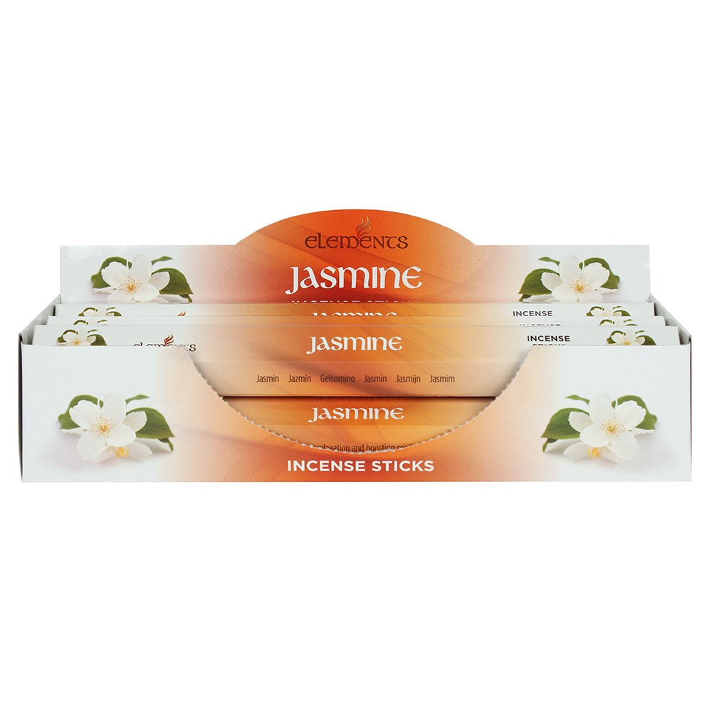 A hand holding an individual pack of Elements Jasmine incense cones, featuring orange and white floral packaging against a warm background.