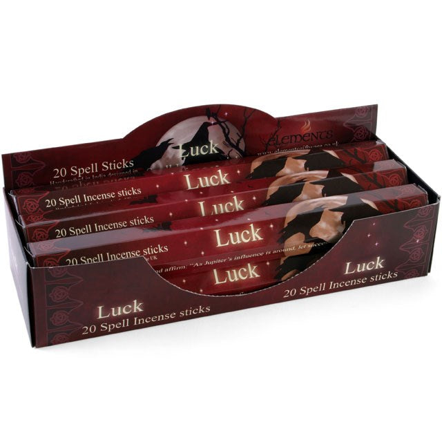 Retail counter display box filled with Elements Luck Spell incense stick packs, featuring a rich burgundy and brown mystical themed design