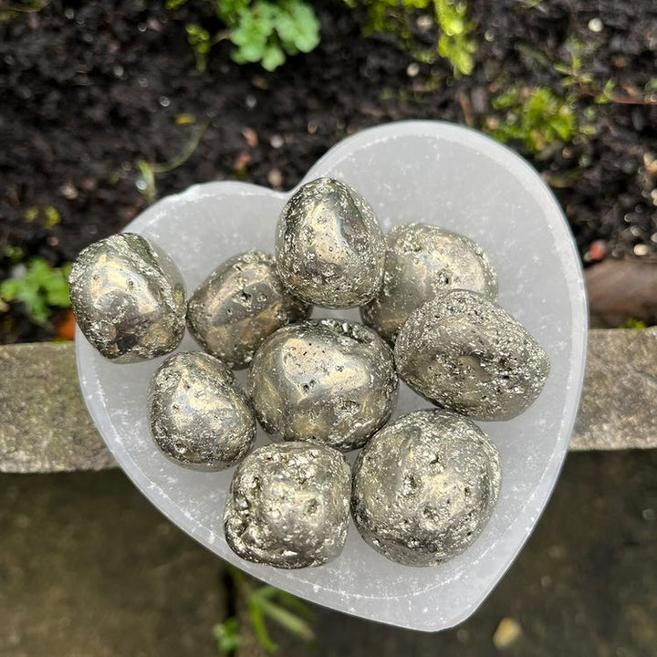 A heart shaped bowl containing shiny Pyrite crystals