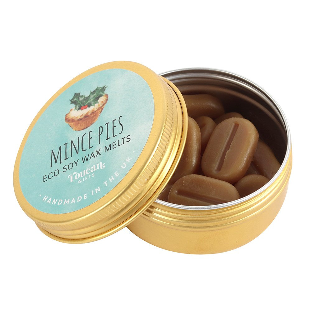 An open golden aluminium tin filled with brown, coffee-bean-shaped eco soy wax melts, showcasing the circular blue festive product label leaning against the base on a clean white background to inspire a cosy holiday atmosphere.