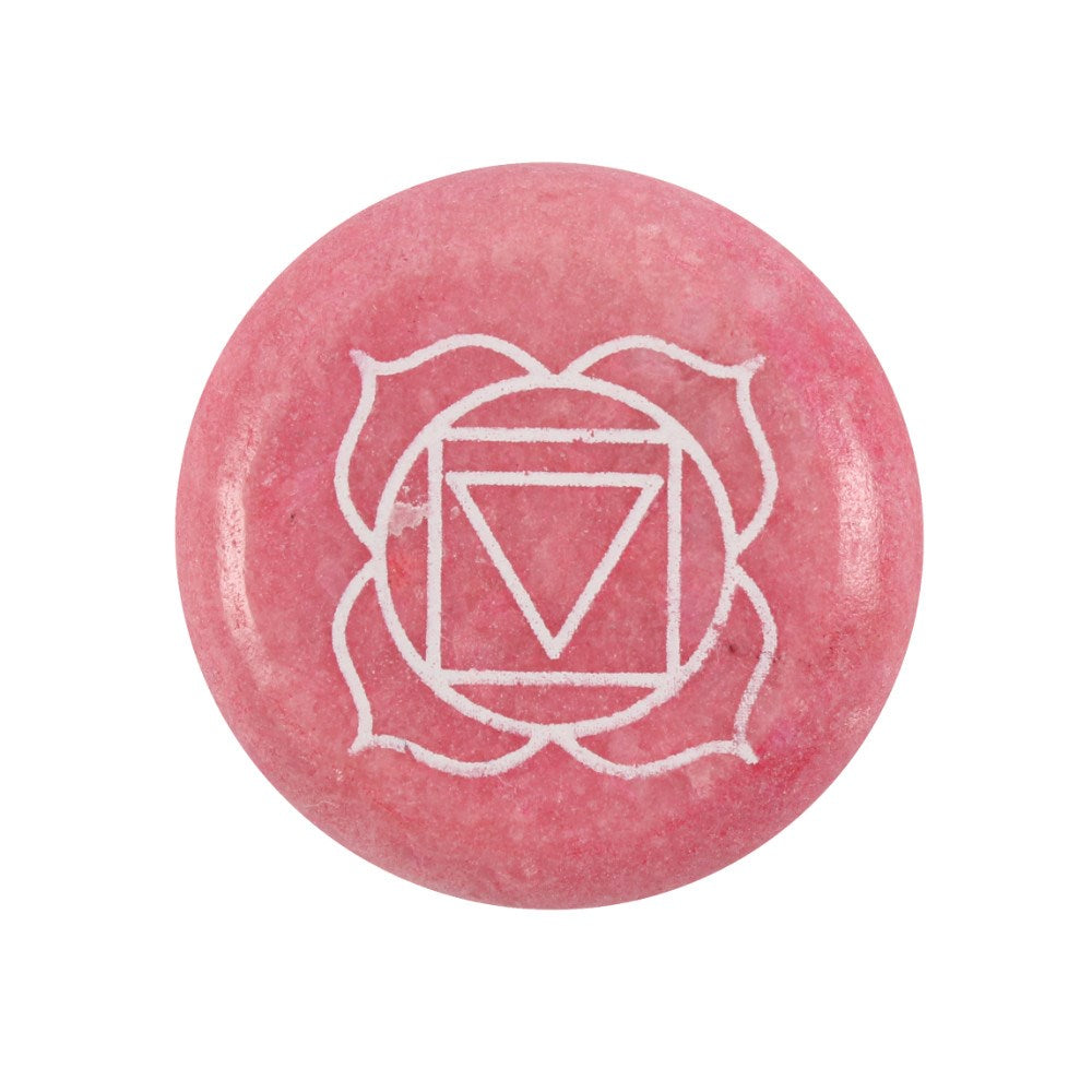 A close-up view of a circular, smooth deep red meditation stone resting against a clean white backdrop. The polished gemstone showcases rich red tones and unique natural markings, beautifully engraved with the geometric Root chakra symbol in a crisp white finish to welcome grounding comfort and soothing peace.