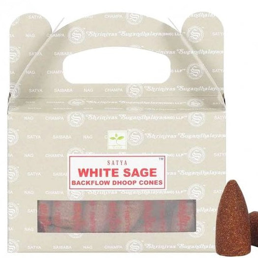 A crisp front view of a grey cardboard carry-handle box of Satya White Sage backflow incense cones resting against a clean white backdrop. The packaging features a clear rectangular window displaying the bundled dhoop cones inside, with a single hand-rolled brown cone placed prominently in the foreground to invite purifying Third Eye chakra clarity.