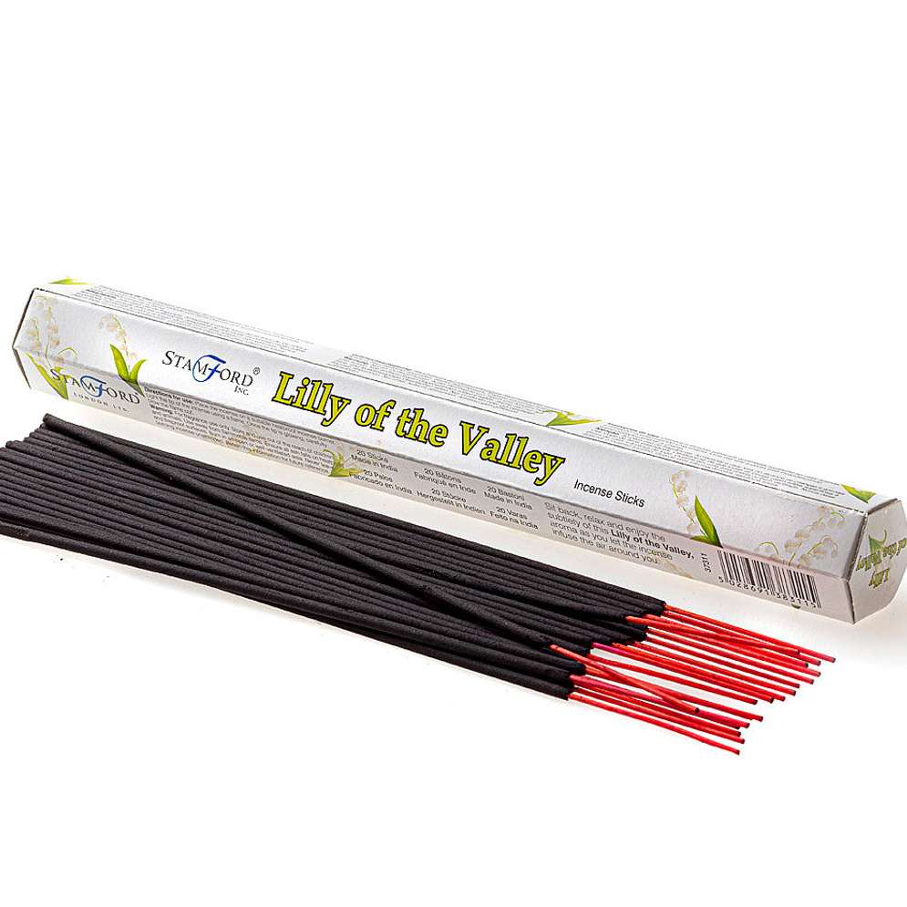 A crisp studio product shot showcasing a hexagonal white cardboard box of authentic Stamford Lily of the Valley incense sticks. A bundle of unlit, dark hand-rolled incense sticks with distinct bright pink wooden bases is spread out neatly in the foreground against a solid white background.