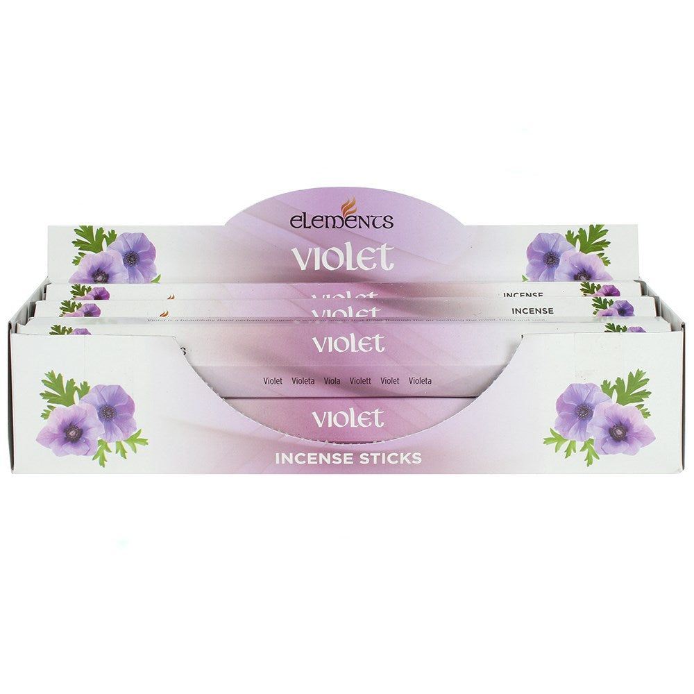 A front view of a white and purple cardboard counter display box filled with Elements Violet incense sticks against a white setting. The packaging is decorated with purple floral graphics of sweet violet blossoms, highlighting its soothing peace intention and nostalgic, sweet aroma.