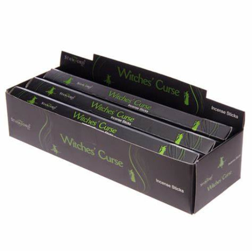 A front three-quarter view of a dark charcoal-black and vibrant green counter display box filled with packs of Stamford Witches Curse incense sticks against a clean white backdrop. The themed packaging highlights the premium brand graphics designed to welcome a spooky, dark magical vibe, casting a soothing aloe vera aroma to settle an overactive mind.